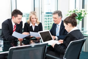 Business - meeting in an office, the businesspeople are discussing a document